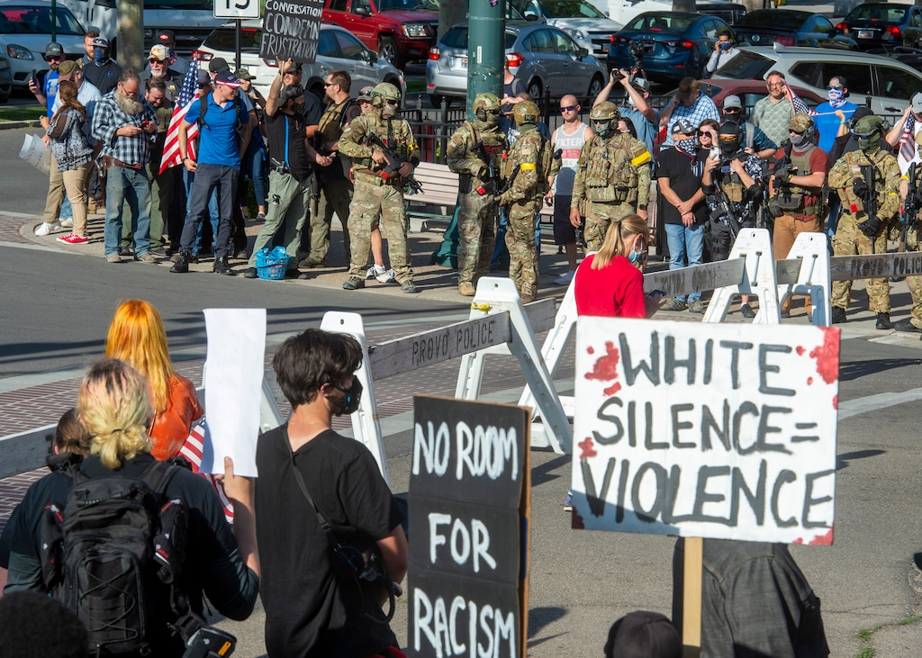 (Rick Egan  |  The Salt Lake Tribune)   Protesters chant Black Lives Matter chants on Center Street in Provo, as counter protesters occupy the other three corners, many armed like soldiers, Wednesday July 1, 2020.
