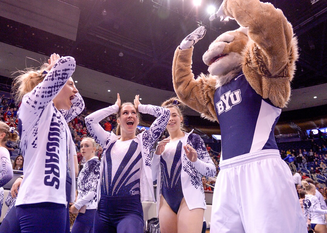 Leah Hogsten  |  The Salt Lake Tribune  BYU's Shannon Evans dances with Cosmo as No. 3 University of Utah gymnastics team meets BYU gymnastics at the Marriot Center, Jan. 10, 2019.