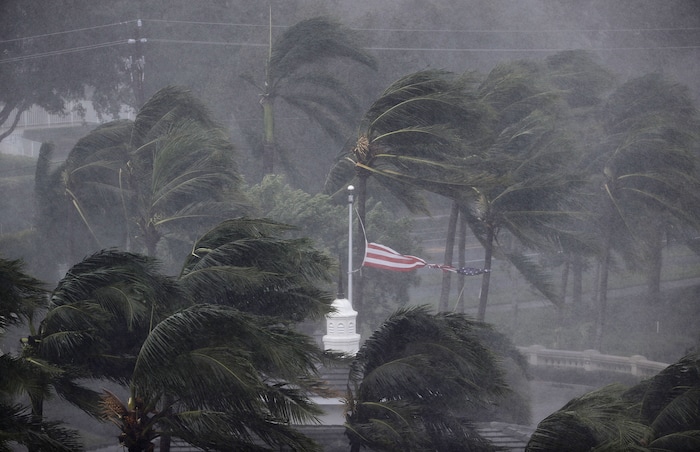 An American flag is torn as Hurricane Irma passes through Naples, Fla., Sunday, Sept. 10, 2017. (AP Photo/David Goldman)