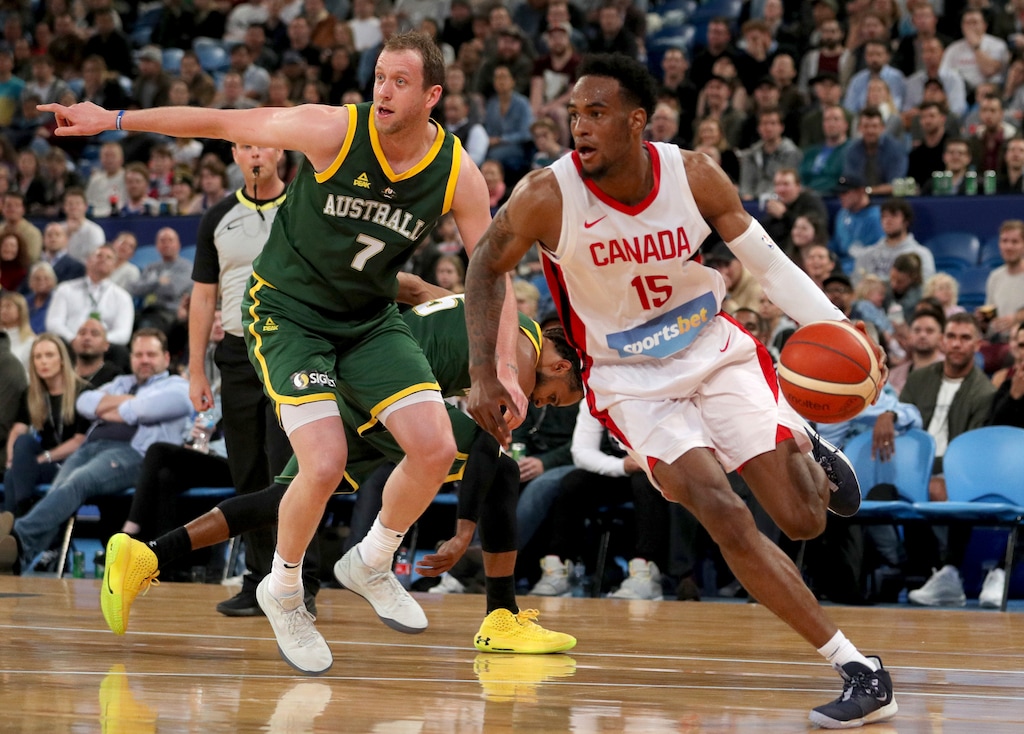 Canada's Oshae Brissett, right, drives past Joe Ingles, of Australia, during an exhibition basketball game in Perth, Australia, Friday, Aug. 16, 2019. (Richard Wainwright/AAP Image via AP)