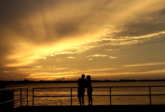 (Patti Blake | News Herald | The Associated Press) A couple is silhouetted against the sunset at the St. Andrews Marina in Panama City, Fla., Tuesday, Oct. 9, 2018, ahead of Hurricane Michael.