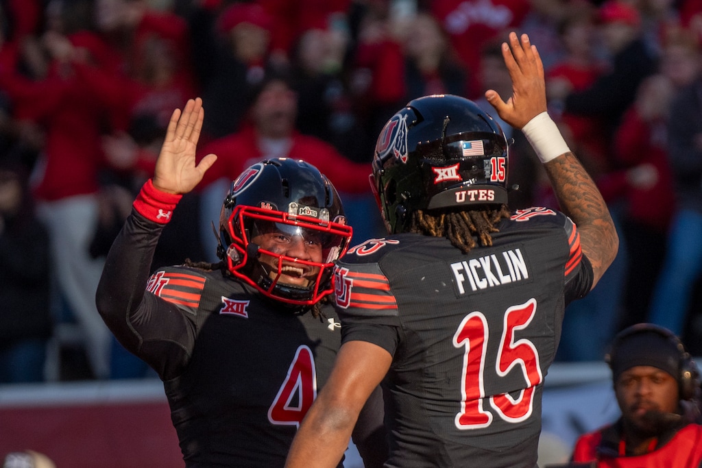 (Rick Egan | The Salt Lake Tribune) Utah Utes quarterback Devon Dampier (4) congratulates Utah Utes quarterback Byrd Ficklin (15) after Fiklin's touchdown, in Big-12 Football action between the Utah Utes and the Kansas State Wildcats at Rice-Eccles Stadium, on Saturday, Nov. 22, 2025.