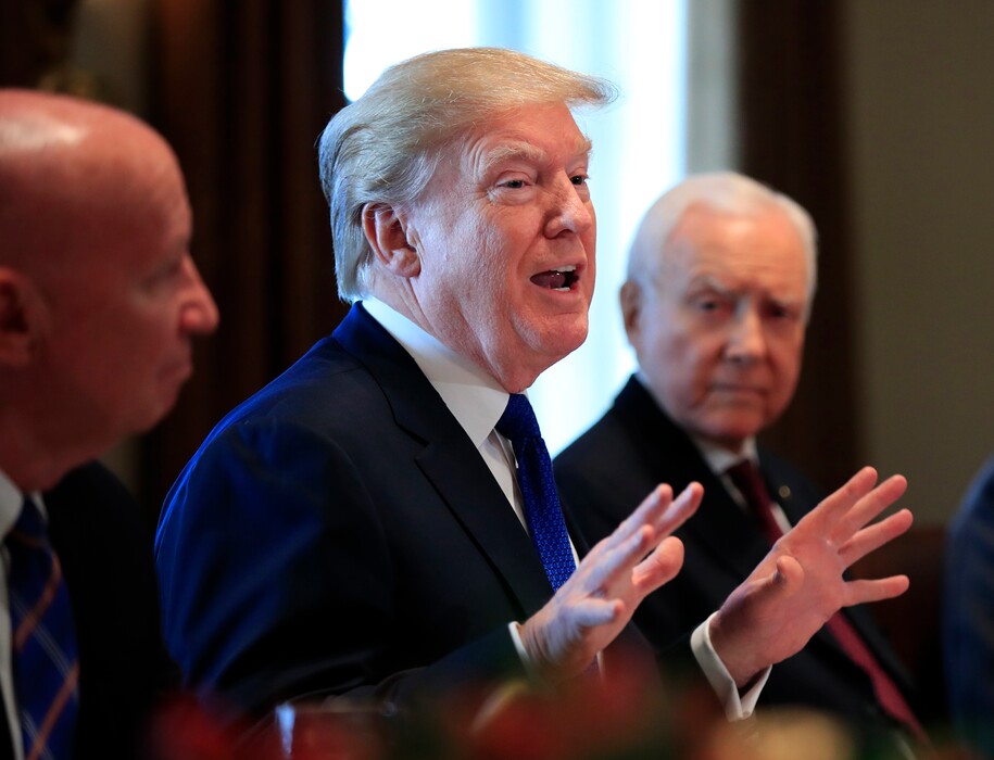 President Donald Trump, flanked by Rep. Kevin Brady, R-Texas, left, and Sen. Orrin Hatch, R-Utah, right, speaks during a bicameral meeting with lawmakers working on the tax cuts in the Cabinet Room of the White House in Washington, Wednesday, Dec. 13, 2017. (AP Photo/Manuel Balce Ceneta)