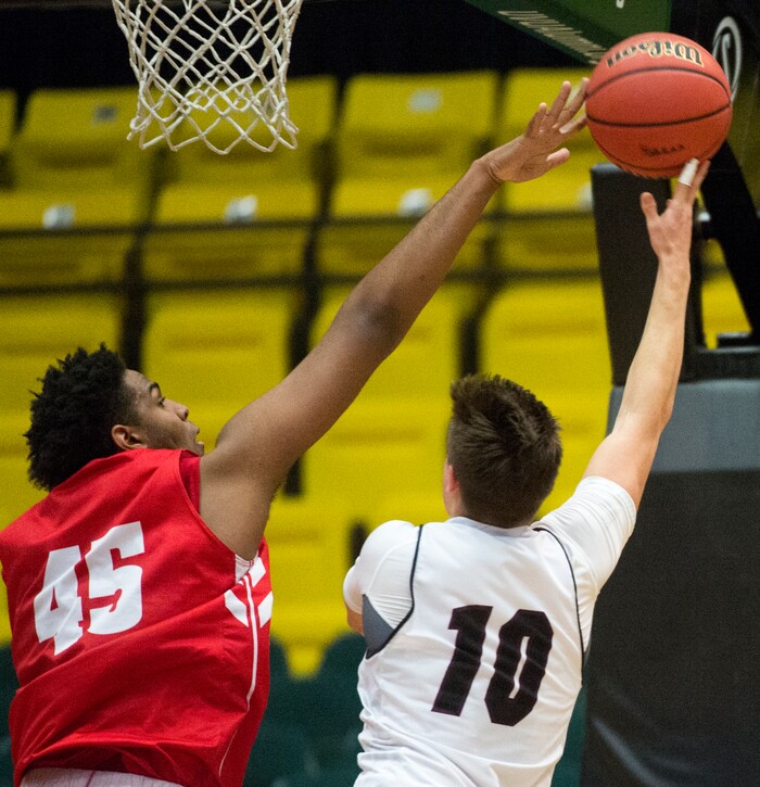 (Rick Egan  |  The Salt Lake Tribune)   East Leopards Mikey Frazier (45)  blocks a shot by Jordan Beatdiggers Crew Wakley (10), in 5A basketball playoff action between the East Leopards and the Jordan Beatdiggers at the UCCU Center in Orem, Monday, Feb. 26, 2018.