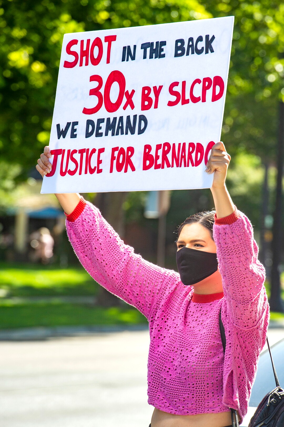 (Rick Egan  |  The Salt Lake Tribune)     Jeanette Padilla holds a sign for the cars on 500 South, in front of the District Attorney's Office, in Salt Lake City, during a protest to draw attention to Chad Brienholt and Bryan Valencia, who, like Bernardo Palacios were killed by the police, Wednesday, July 8, 2020.