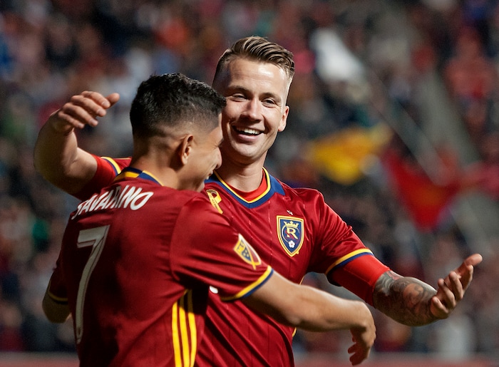 (Michael Mangum  |  Special to the Tribune)  Real Salt Lake midfielder Albert Rusnak (11) hugs teammate Jefferson Savarino (7) after Savarino scored a second half goal during their MLS match against the Portland Timbers at Rio Tinto Stadium in Sandy, UT on Saturday, September 16, 2017.