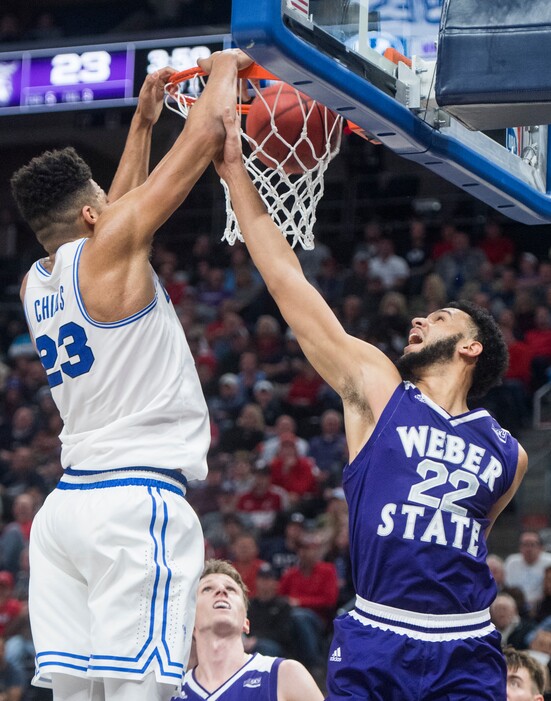 (Rick Egan  |  The Salt Lake Tribune)  Brigham Young Cougars forward Yoeli Childs (23) dunks the ball over Weber State Wildcats guard Ryan Richardson (22), in Beehive Classic basketball action at the Vivint SmartHome Arena, Saturday, December 9, 2017.
