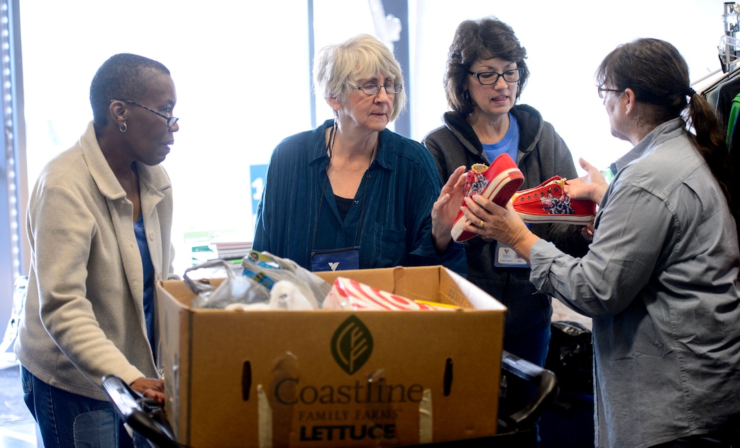 (Steve Griffin  |  The Salt Lake Tribune)  Volunteers Erma Decaria, Peggy Montrone, Kathy Wagner and De Buchanan sort donations at Volunteers of America, in Salt Lake City Monday December 11, 2017. The group volunteers their time to organize donated items intended for homeless young people.