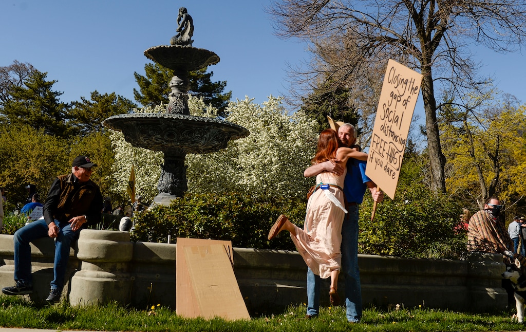 (Leah Hogsten | The Salt Lake Tribune) Aaron Davidson holds a sign inviting others to hug him at an April 2020 protest about coronavirus restrictions. Davidson has since cited misinformation about vaccines while speaking against monkeypox.