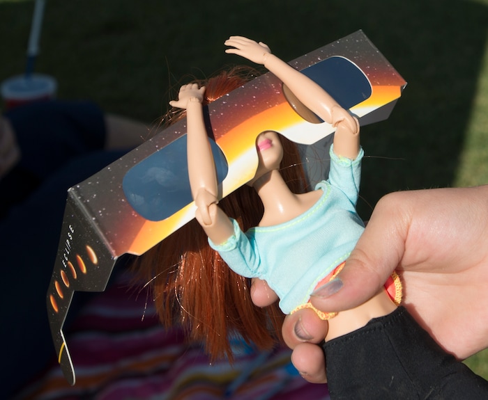 (Rick Egan  |  The Salt Lake Tribune)   Grace Gannon, 8,  of Idaho Falls, prepares her Barbie for the solar eclipse at Melaleuca Baseball Park, in Idaho Falls, Monday, August 21, 2017.


