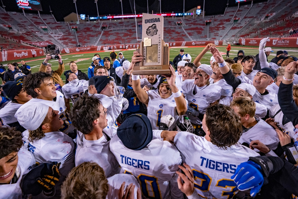 (Rick Egan | The Salt Lake Tribune) The Orem High Tigers celebrate their 5A Championship 42-7 win over the Springville Red Devils at Rice-Eccles Stadium on Thursday.