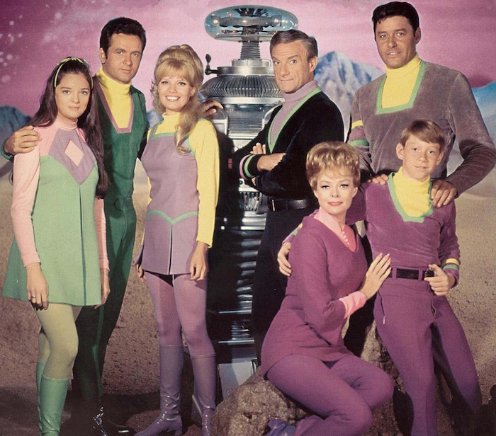 (Photo courtesy of CBS) Angela Cartwright at Penny Robinson, Mark Goddard as Don West, Marta Kristen as Judy Robinson, the Robot, Jonathan Harris as Dr. Smith, June Lockhart as Maureen Robinson, Guy Williams as John Robinson, and Billy Mumy as Will Robinson in the original “Lost in Space.”