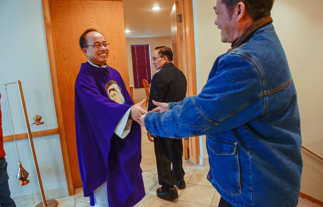 Leah Hogsten  |  The Salt Lake Tribune l-r Rev. Tai Trong Nguyen of Our Lady of Perpetual Help Catholic church bids parishoners goodby after morning mass, Wednesday, Dec. 5, 2018 in Kearns. The mostly Vietnamese congregation purchased the former Church of Jesus Christ of Latter-day Saints church in 2003. Mormons now make up less than 50% of Salt Lake County. 