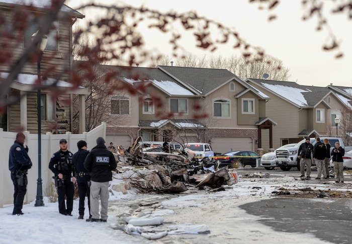 (Leah Hogsten | The Salt Lake Tribune) Weber County emergency personnel and firefighters work the scene of a small, private plane that crashed in a residential neighborhood in Roy, Jan 15, 2020. A 64-year-old pilot was killed.