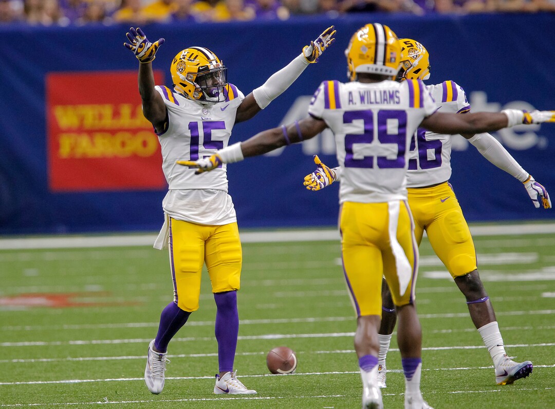 LSU cornerback Kary Vincent Jr. (15) celebrates with cornerback Andraez Williams (29) and safety John Battle (26) after breaking up a pass intended for BYU wide receiver Talon Shumway during the second half of an NCAA college football game in New Orleans, Saturday, Sept. 2, 2017. (AP Photo/Scott Threlkeld)