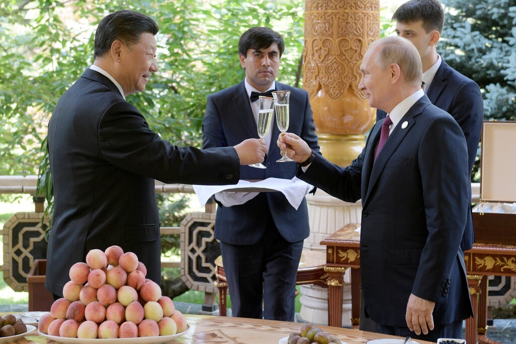 FILE - In this June 14, 2019, file photo, Russian President Vladimir Putin, right, toasts with Chinese President Xi Jinping prior to the Conference on Interaction and Confidence Building Measures in Asia (CICA) in Dushanbe, Tajikistan. Putin and Xi have established themselves as the world’s most powerful authoritarian leaders in decades. Now it looks like they want to hang on to those roles indefinitely. Putin's sudden announcement of constitutional changes that could allow him to extend control way beyond the end of his term in 2024 echoes Xi’s move in 2018 to eliminate constitutional term limits on the head of state. (Alexei Druzhinin, Sputnik, Kremlin Pool Photo via AP, File)