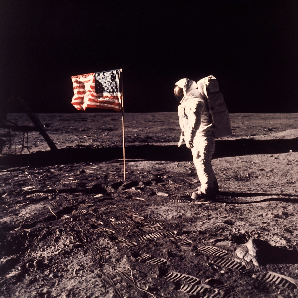 FILE - In this July 20, 1969, file photo, astronaut Edwin E. "Buzz" Aldrin Jr. poses for a photograph beside a U.S. flag planted on the moon during the Apollo 11 mission. On Friday, April 13, 2018, The Associated Press has found that stories circulating on the internet that Aldrin passed a lie detector test about alien life are untrue. (Neil A. Armstrong/NASA via AP)
