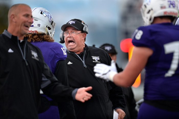 (Scott Sommerdorf   |  The Salt Lake Tribune)   Lehi head coach Ed Larson has a conversation with QB Cammon Cooper during first half play. Lehi led Olympus 26-0 late in the second half, Friday, September 22, 2017.
