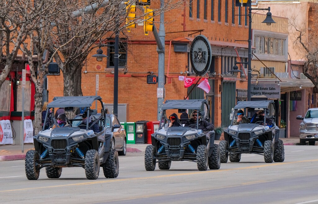 (Leah Hogsten | The Salt Lake Tribune) Several off-road utility terrain vehicles (UTVs) motor down Main Street in Moab towards the Sand Flats Recreation Area trail, located just 4 miles from downtown, Feb. 19, 2021. 