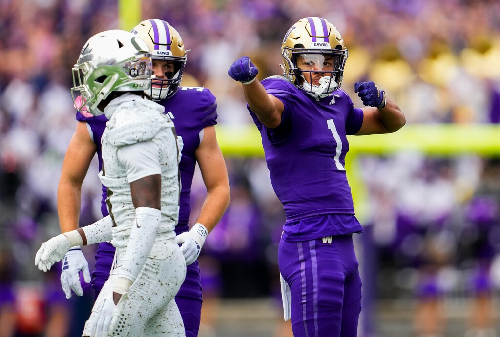 (Lindsey Wasson | AP) Washington wide receiver Rome Odunze (1) reacts after making a catch against Oregon defensive back Jahlil Florence, left, on Oct. 14 in Seattle.