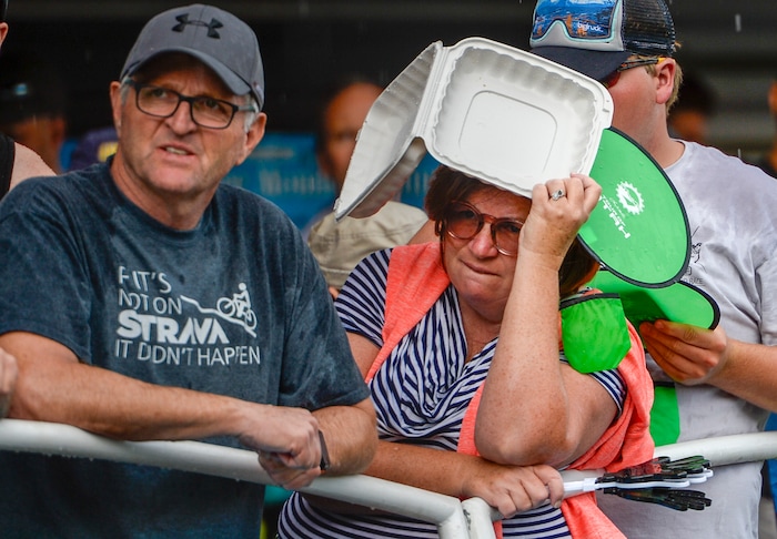 Leah Hogsten | The Salt Lake Tribune Fans lining Park City's Main Street braved the downpour minutes prior to cyclists crossing the finish at the Tour of Utah's Stage 6, Sunday, August 12, 2018.