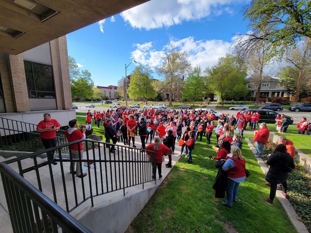 (Connor Sanders l The Salt Lake Tribune) Protesters hold signs asking for more pay for teachers and staff during a Salt Lake City School District board meeting on May 3, 2022.