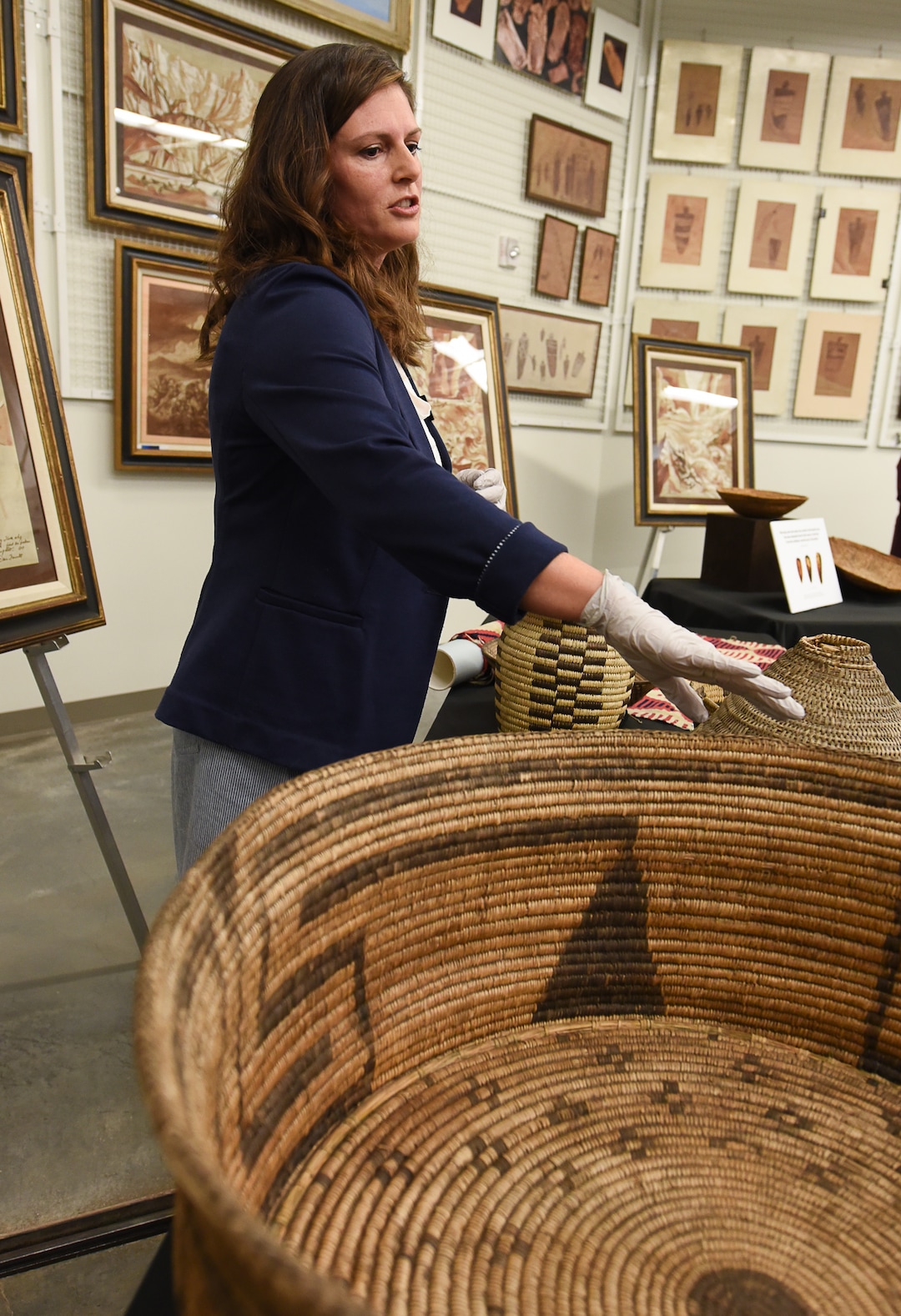 (Francisco Kjolseth  |  The Salt Lake Tribune)  Lisbeth Louderback, curator of archeology at the Natural History Museum of Utah points out the unique qualities of a basket by the Tahono O'odom tribe that was collected by famed explorer John Westley Powell and recently added to the museum collection. Numerous artifacts will be displayed during a public event at the museum Saturday, Sept. 22, for one day only due to the delicate nature of the items.