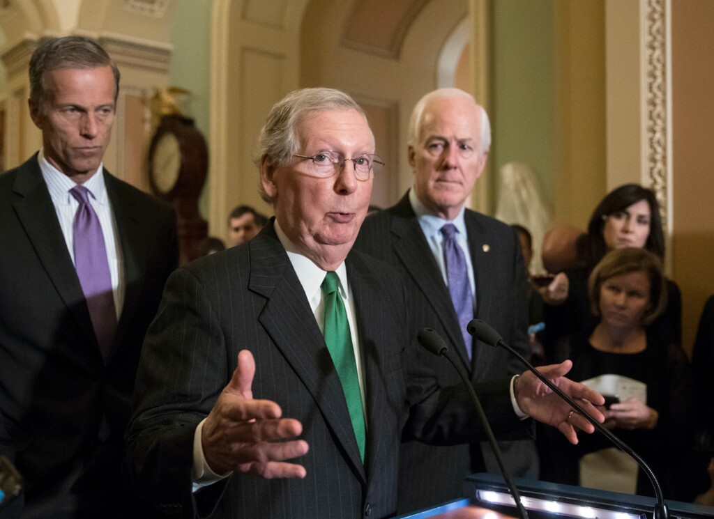 In this Oct. 17, 2017, photo, Senate Majority Leader Mitch McConnell, R-Ky., flanked by Sen. John Thune, R-S.D., left, and Majority Whip John Cornyn, R-Texas, announces to reporters that the Senate is moving ahead on a Republican budget plan at the Capitol in Washington. Senate Republicans seem to be on cruise control to pass a $4 trillion budget plan that shelves GOP deficit concerns in favor of the party’s drive to cut taxes. (AP Photo/J. Scott Applewhite)
