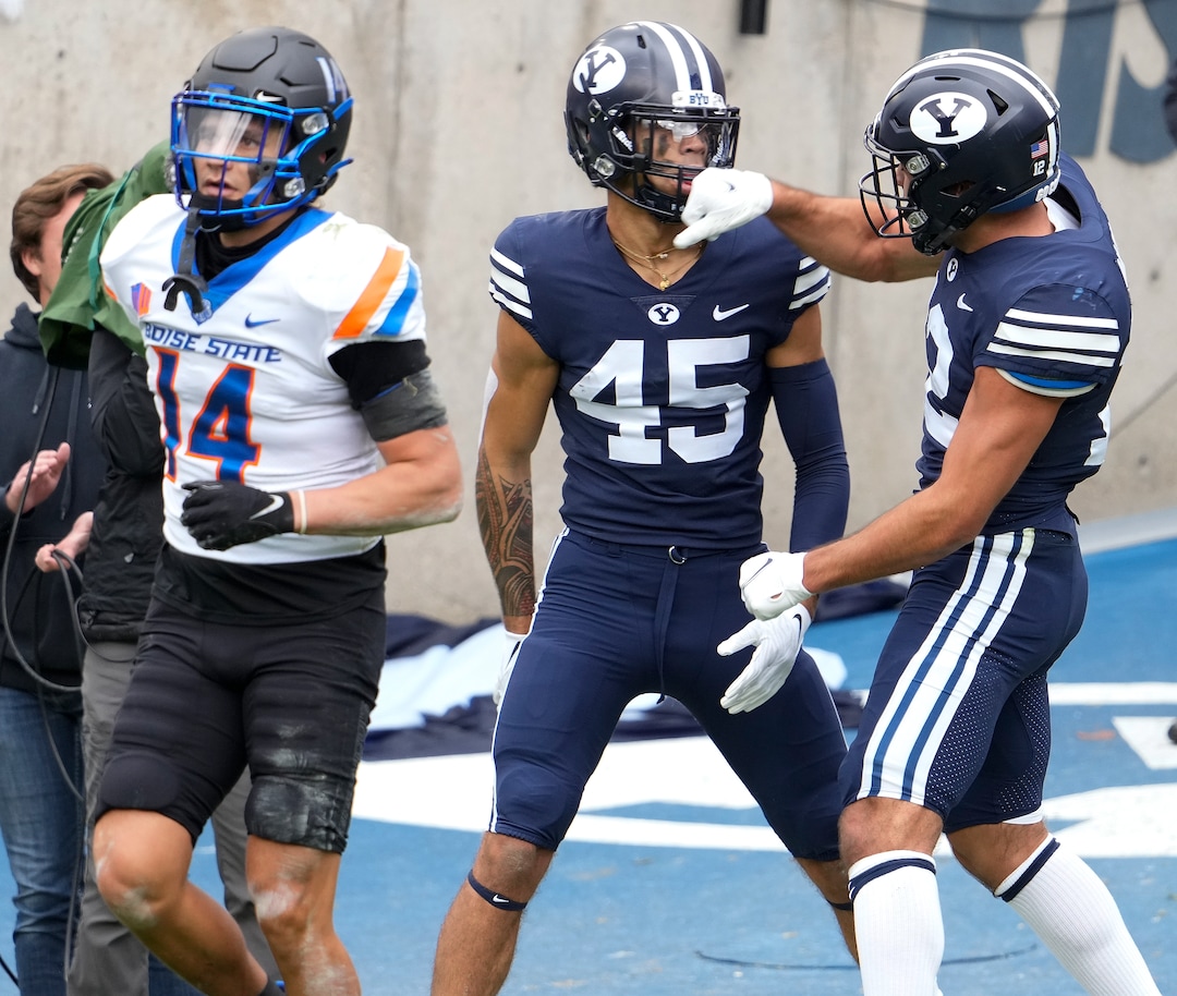 (Leah Hogsten | The Salt Lake Tribune) Brigham Young Cougars wide receiver Samson Nacua (45) is pretend knocked out by Brigham Young Cougars wide receiver Puka Nacua (12) after Nacua's touchdown as No. 10 Brigham Young University hosts Boise State at LaVell Edwards Stadium, Oct. 9, 2021.
