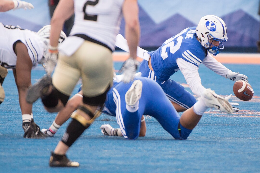 (Jeremy Harmon  |  The Salt Lake Tribune) Brigham Young Cougars wide receiver Dax Milne (82) fumbles the ball as BYU faces the Western Michigan Broncos in the Famous Idaho Potato Bowl in Boise, Idaho, on Friday, Dec. 21, 2018.