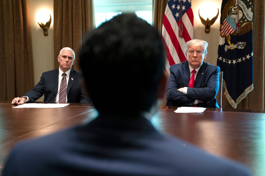 (Evan Vucci | AP photo) Vice President Mike Pence and President Donald Trump listen as people share their stories of recovering from COVID-19, in the Cabinet Room of the White House, Tuesday, April 14, 2020, in Washington.