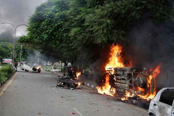 Vehicles set alight by Dera Sacha Sauda sect members burn in the streets of Panchkula, India, Friday, Aug. 25, 2017. Deadly riots have broken out in a north Indian town after a court convicted a guru of raping two of his followers. Mobs also attacked journalists and set fire to government buildings and railway stations. (AP Photo/Altaf Qadri)
