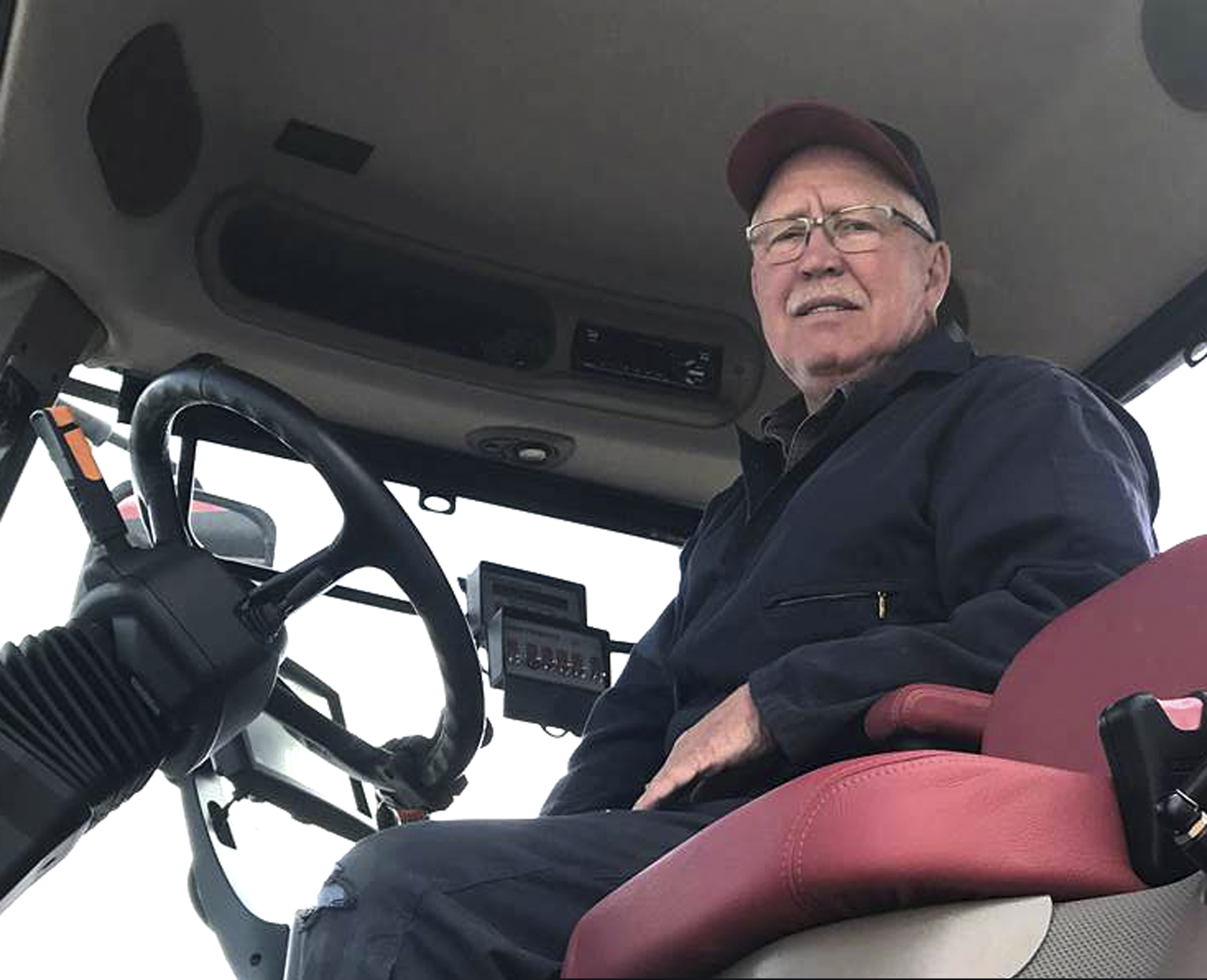(Carmen Richards via AP) Randy Richards, a 65-year-old farmer near Hope, N.D., poses for a photo Friday, May 10, 2019, at the request of The Associated Press, says the tariff war of the past year and a half has hit hard, and he was angry that more may be coming. Richards says he farms more than 6,000 acres of wheat, barley, soybeans, pinto beans and corn, and says tariffs have driven up the cost of the raw products he needs to run and supply his business and driven down the prices of what he has to sell.