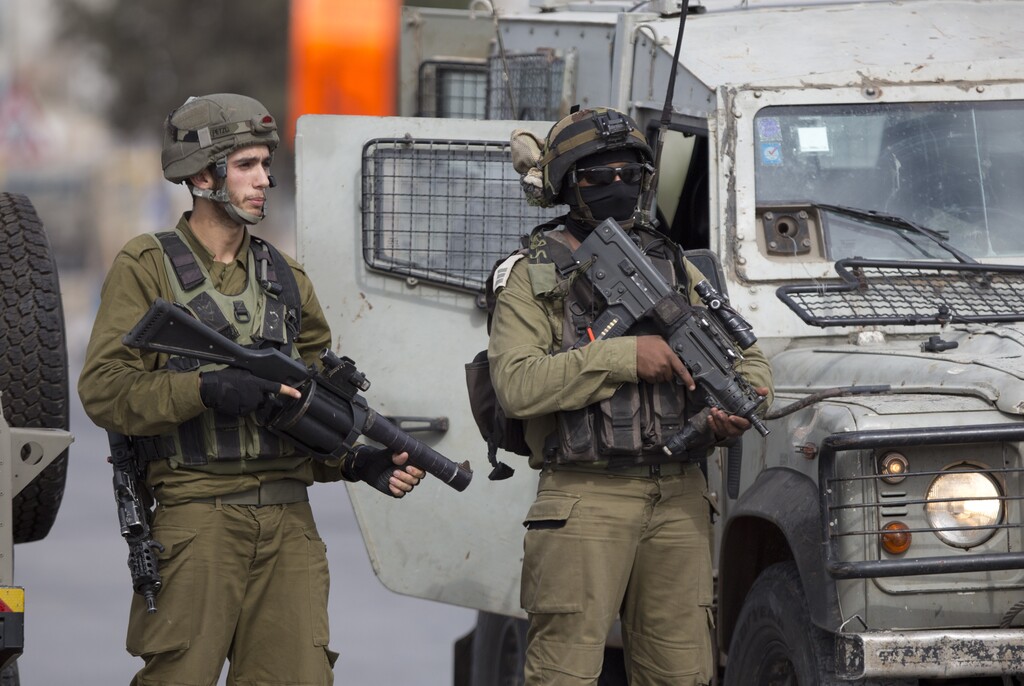 Israeli security forces stand guard at the Jalama checkpoint near Jenin, West Bank, Saturday, Oct. 24, 2015. (AP Photo/Majdi Mohammed)