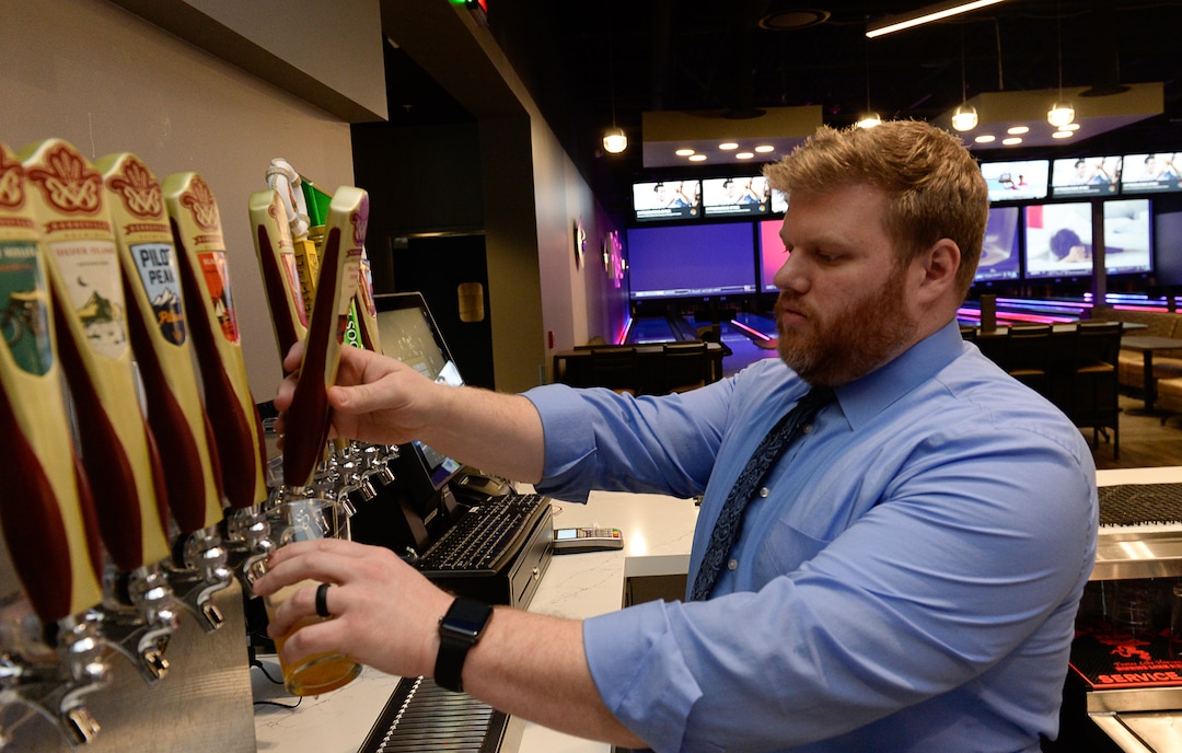 (Francisco Kjolseth  |  The Salt Lake Tribune)  Manager Jordan Herkimer pours a selection of Bonneville brews at the new Pins & Ales 21+ bar that is adjacent to the all ages All Star Bowling which opened a new 70,000 square foot, high-tech bowling and entertainment center at Valley Fair Mall, in West Valley City. It has 32 lanes with luxury seating, laser tag and virtual reality games as well as old-school air hockey, basketball and bumper cars.