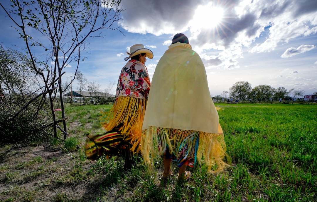 (Francisco Kjolseth | The Salt Lake Tribune) Sarah Cuch left, and her friend Vicky Yellowhorse, get ready to enter a large circle made of woven willow, the first time that the reservation of Whiterocks in eastern Utah has held the traditional Ute Bear Dance on Thursday, May 19, 2022.