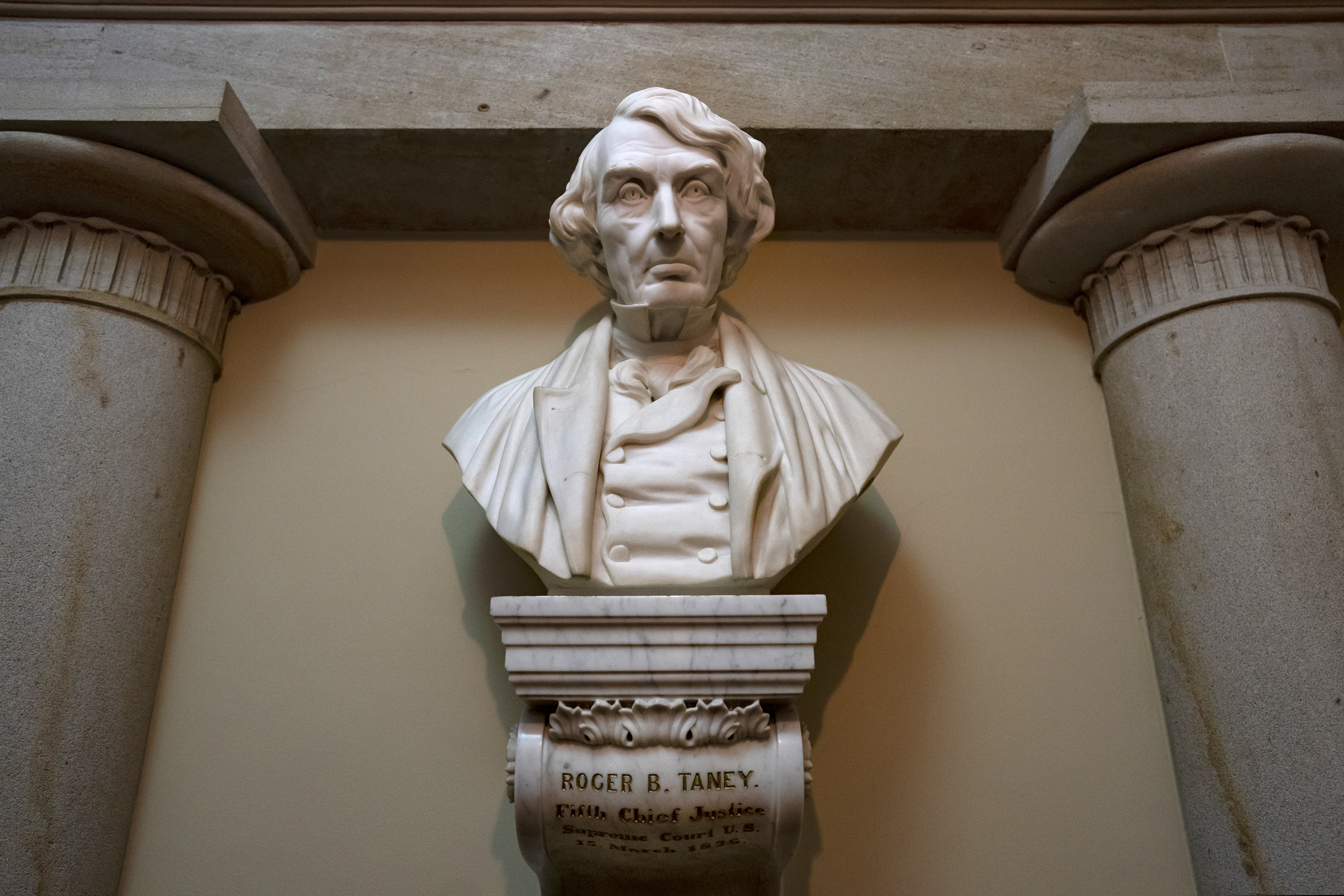FILE - In this March 9, 2020 file photo, a marble bust of Chief Justice Roger Taney is displayed in the Old Supreme Court Chamber in the U.S. Capitol in Washington.  (AP Photo/J. Scott Applewhite)