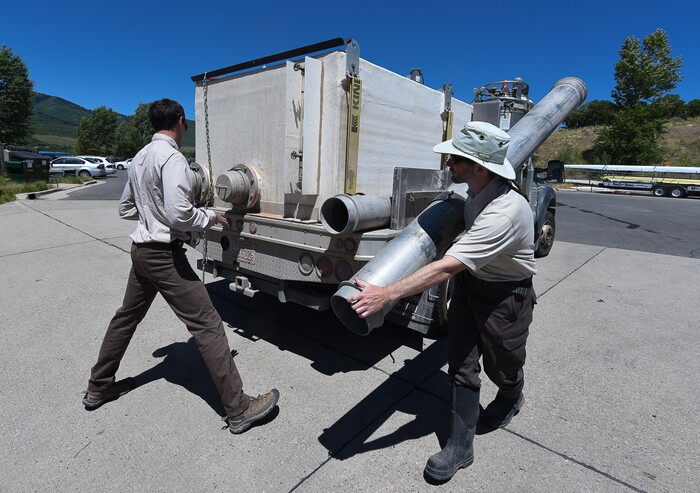 (Francisco Kjolseth | The Salt Lake Tribune) Chris Crocket, left, with Mammoth Creek Hatchery, and Chris Crocket, Regional Aquatics Manager for the Division of Wildlife Resources get ready to introduce around 40,000 splake, a sterile cross between lake trout and brook trout, into the Jordanelle Reservoir on Thursday, June 21, 2018. Measuring four to five inches long, splake will quickly grow and could reach adult lengths of more than two feet long as part of ongoing management plans at the reservoir that currently holds numerous other fish species.