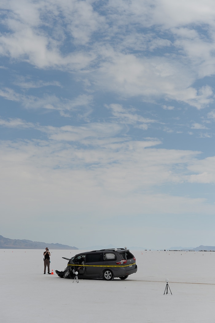 (Francisco Kjolseth | The Salt Lake Tribune) Highway patrol investigate the scene of a deadly crash at Utah's Bonneville Salt Flats along the sidelines of Speed Week following a head-on collision between two vehicles carrying support crew traveling between the pits and the entrance to the salt along the access road on Wednesday, Aug. 16, 2017. One person was killed and five injured, all of whom were said to be members of support crews for racing drivers.
