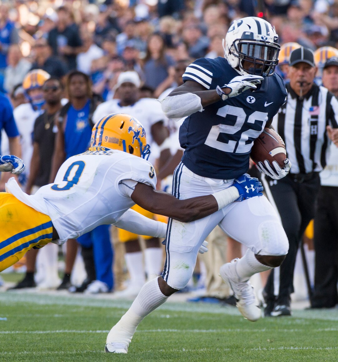 (Rick Egan  |  The Salt Lake Tribune)    Brigham Young Cougars running back Squally Canada (22) gets past McNeese State Cowboys defensive back Trent Jackson (9), in football action Brigham Young Cougars vs McNeese State Cowboys at Lavell Edwards Stadium, Saturday, Sept. 22, 2018.