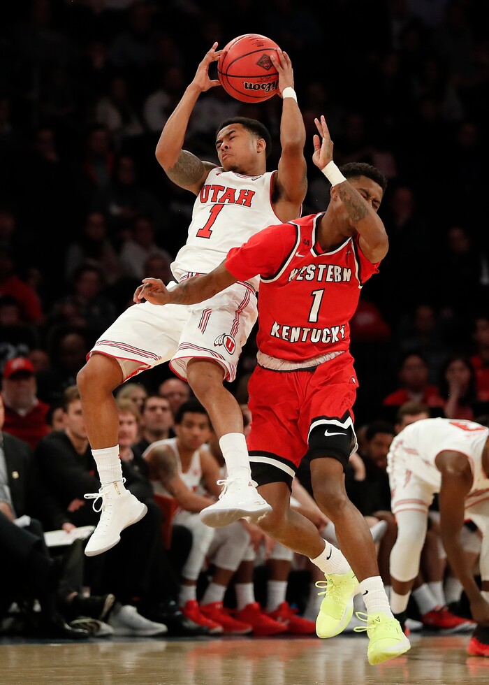 Utah guard Justin Bibbins (1) and Western Kentucky guard Lamonte Bearden (1) collide near halfcourt during the fourth quarter of an NCAA college basketball game in the semifinals of the NIT, Tuesday, March 27, 2018, in New York. Utah won 69-64. (AP Photo/Julie Jacobson)