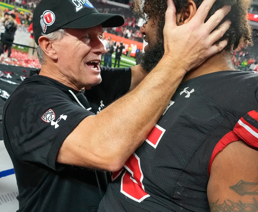 (Leah Hogsten | The Salt Lake Tribune) Utah Utes head coach Kyle Whittingham celebrates the win with Utah Utes linebacker Andrew Mata'afa (55). The Utes defeated the Oregon Ducks to win the 2021 Pac12 Football Championship title at Allegiant Stadium in Las Vegas, Dec 3, 2021. 