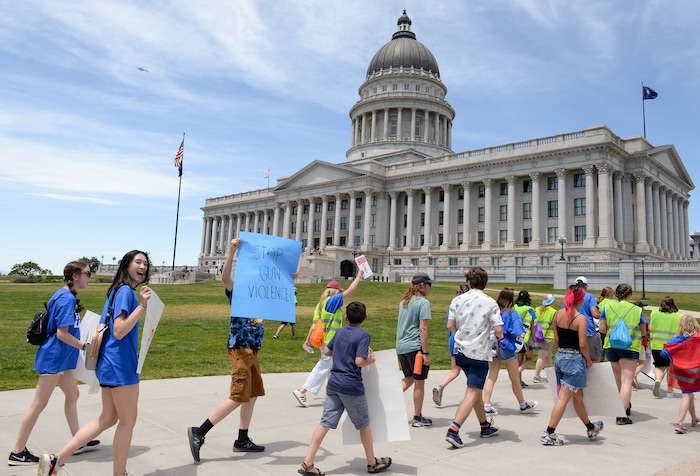 (Chris Samuels | The Salt Lake Tribune) Marchers walk in support of increased gun safety measures at the Capitol in Salt Lake City, Saturday, June 11, 2022.