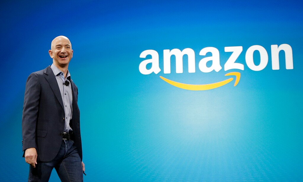 FILE - In this June 16, 2014, file photo, Amazon CEO Jeff Bezos walks onstage for the launch of the new Amazon Fire Phone, in Seattle. Technology leaders are about to come face-to-face with President-elect Donald Trump after fiercely opposing his candidacy, fearful that he would stifle innovation, curb the hiring of computer-savvy immigrants and infringe on consumers’ digital privacy. On Wednesday, Dec. 14, 2016, Silicon Valley luminaries and other technology leaders are headed to Trump Tower in New York to make their peace, or press their case, with Trump and his advisers. Bezos is one of the CEOs expected to attend. (AP Photo/Ted S. Warren, File)