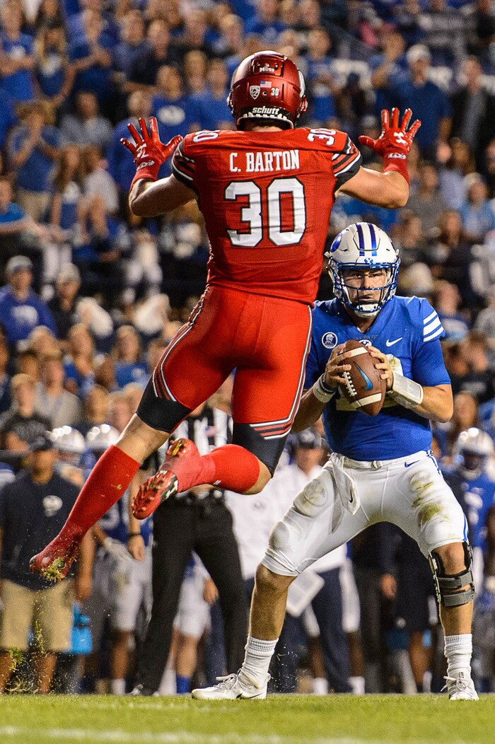(Trent Nelson | The Salt Lake Tribune)  Utah Utes linebacker Cody Barton (30) leaps in front of Brigham Young Cougars quarterback Tanner Mangum (12) as BYU hosts Utah, NCAA football in Provo, Saturday September 9, 2017.