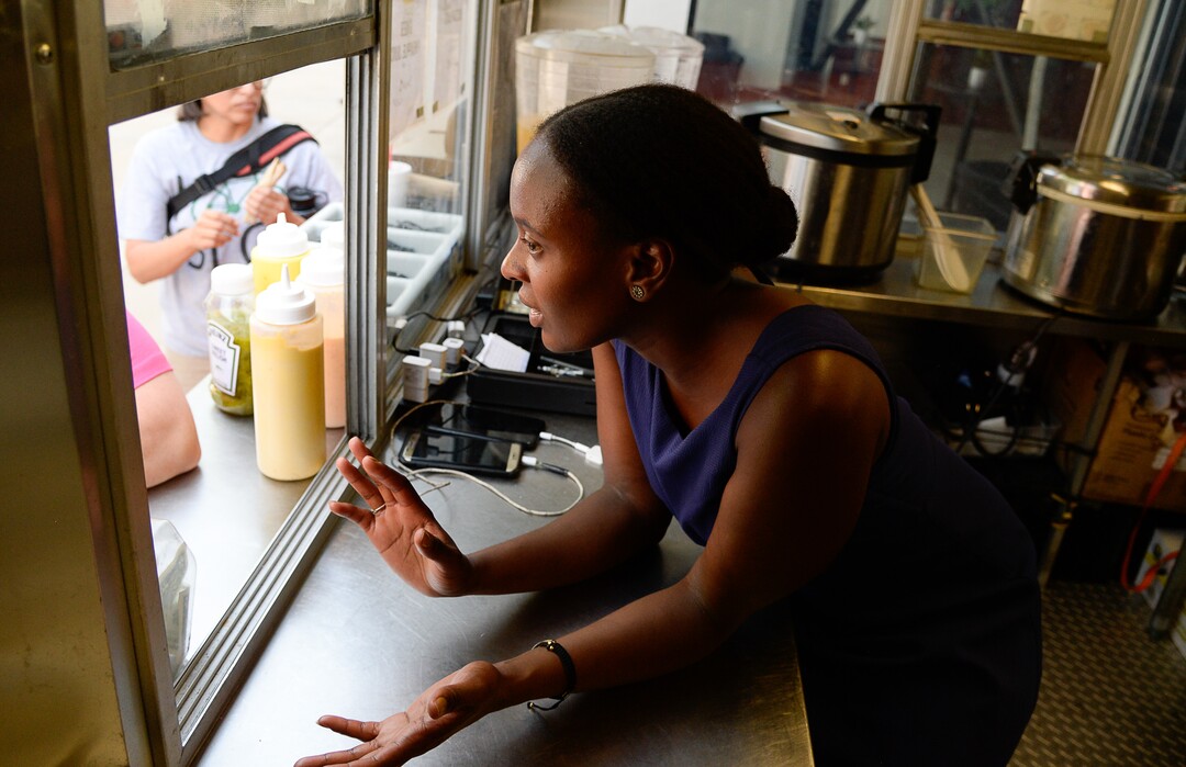 (Francisco Kjolseth  |  The Salt Lake Tribune)  Joelle Twahirwa, owner of the Balabe Senegalese food truck takes orders from customers during Trolley Square Food Truck Night on Wednesday July 17, 2019. Three of the vendors that showed up, along with four others, will vie for the title of Best New Food Truck on Aug. 3 at the Food Truck and Brewery Battle at The Gateway.
