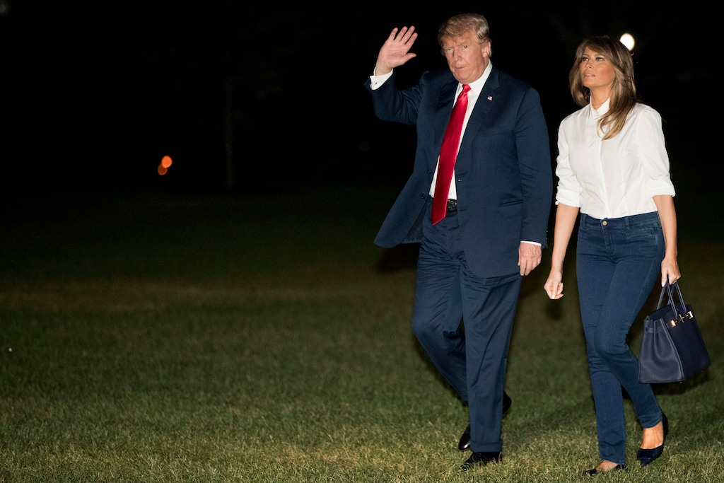President Donald Trump and first lady Melania Trump walk across the South Lawn of the White House in Washington, Monday, July 16, 2018, after a short helicopter ride from Andrews Air Force Base, Md. Trump returns following a meeting with Russian President Vladimir Putin in Helsinki, Finland. (AP Photo/Andrew Harnik)