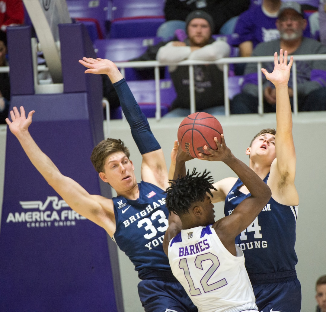 (Rick Egan  |  The Salt Lake Tribune)       Weber State Wildcats guard Israel Barnes (12) collides with Brigham Young Cougars forward Dalton Nixon (33) and Brigham Young Cougars guard Connor Harding (44), in basketball action between Brigham Young Cougars and Weber State Wildcats, at the Dee Event Center in Ogden, Saturday, Dec. 1, 2018.