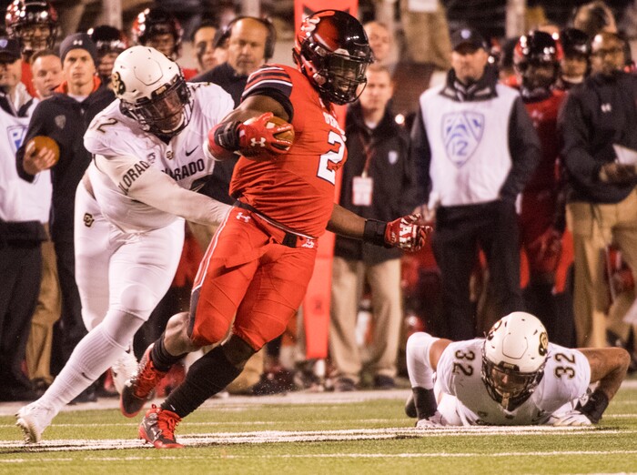 (Rick Egan  |  The Salt Lake Tribune)  Utah Utes running back Zack Moss (2) gets past Colorado Buffaloes defenders Colorado Buffaloes defensive end Leo Jackson III (52) and Colorado Buffaloes linebacker Rick Gamboa (32), in PAC-12 football action Utah Utes vs. Colorado Buffaloes at Rice-Eccles stadium, Saturday, November 25, 2017.