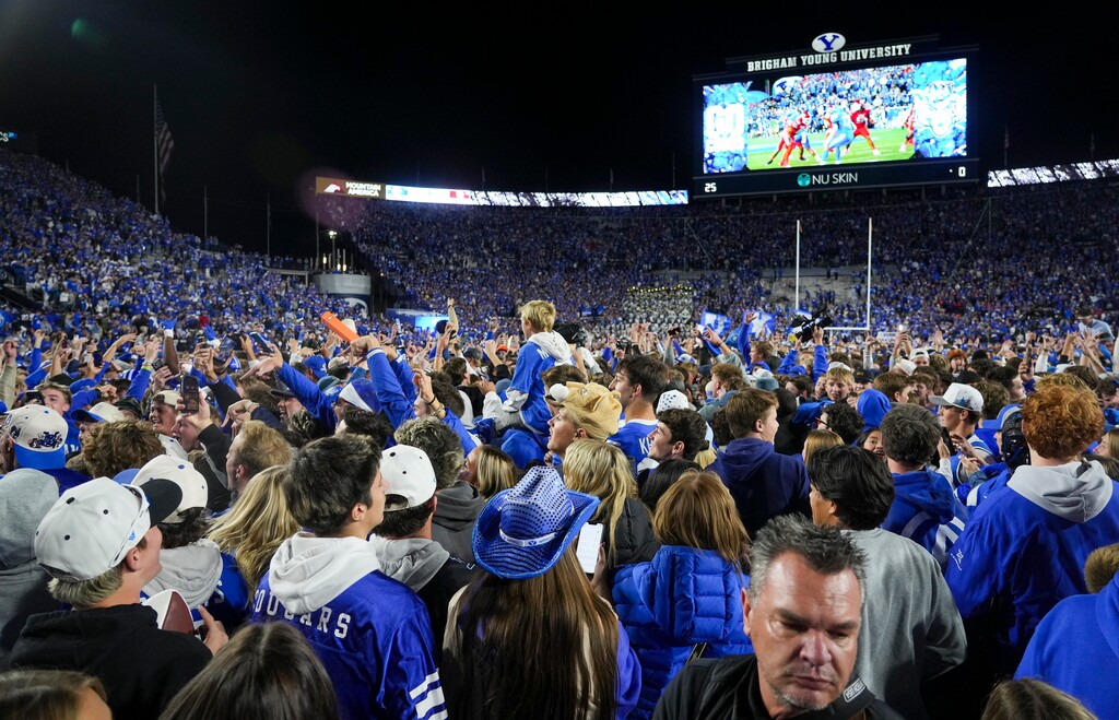 (Bethany Baker  |  The Salt Lake Tribune) BYU Cougars fans celebrate after the game between the BYU Cougars and the Utah Utes in Provo on Saturday, Oct. 18, 2025.